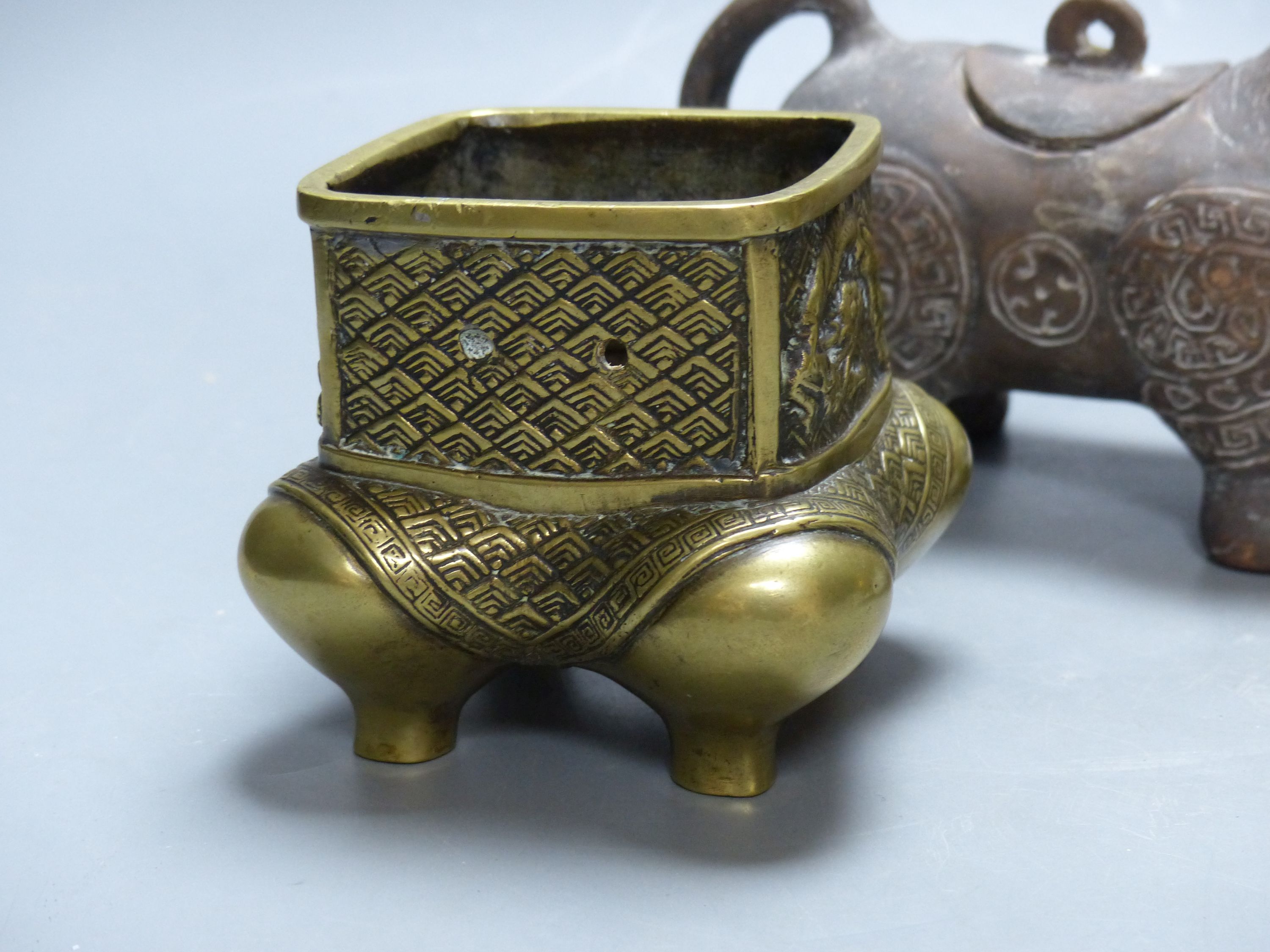 Two Chinese bronze censers and a terracotta vessel, 19cm